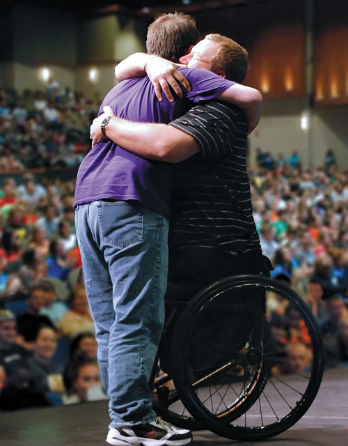 Image of Matt hugging an audience member.